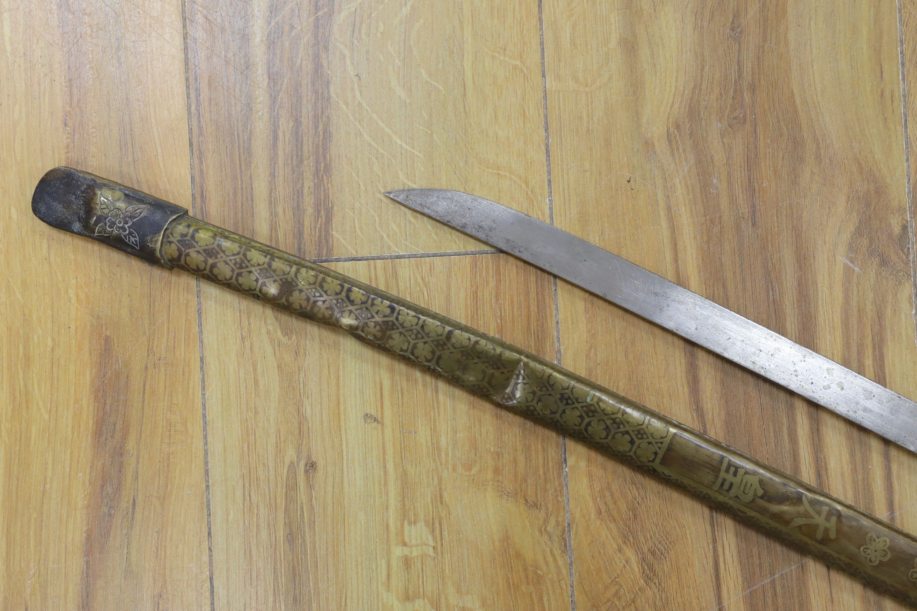 A Chinese sword, single edged blade 64cm long in etched brass scabbard